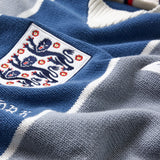 Close-up of a blue and gray sports Wisdom Of Age Knit Soccer jersey Grey Stripe with a prominent emblem.