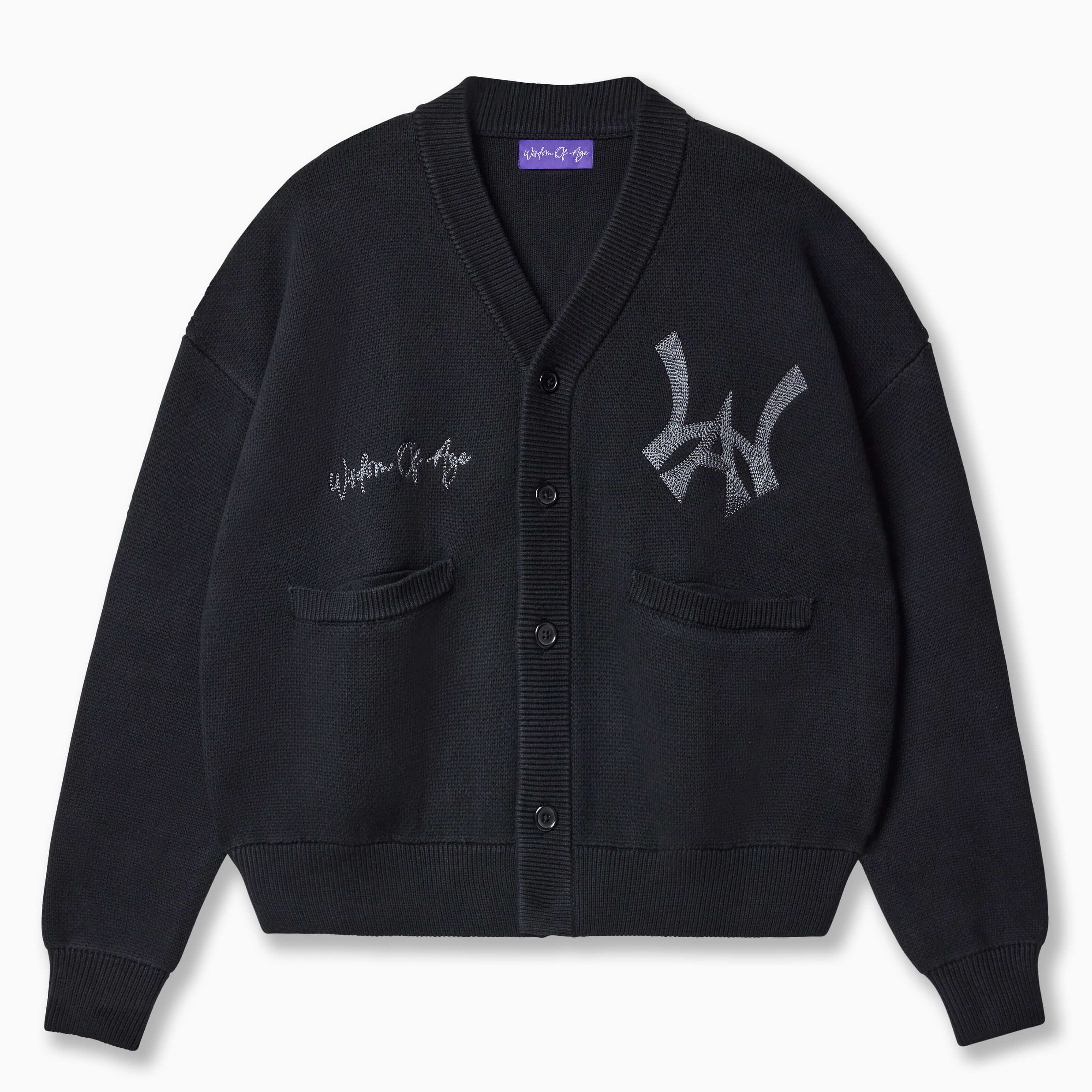 Wisdom of Age Black City Cardigan, Black Cat color wave with the WOA symbol on the top left side of the chest and the brand name “Wisdom of Age” written in script cursive on the upper right side. Two drop-in slip pockets on both sides and a 4 button placket with a v-neck drop.