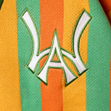 Closer look at the brand logo in a monogram font of connecting the "W" and "A" located on the upper left chest of the cardigan.