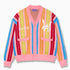 Wisdom of Age “What The?” City Cardigan.  Bubblegum pink base with blue, yellow, orange, red and white vertical stripes in bright hues. With the WA symbol on the top left side of the chest and the brand name “Wisdom of Age” written in script cursive on the right chest. Two slip-in pockets on both sides and a 4 button placket with a v-neck drop.