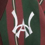 Closer look at the brand logo in a monogram font of connecting the "W" and "A" located on the upper left chest of the cardigan.
