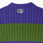Purple and green cable knit T-shirt with the WOA Liberty logo on a white background