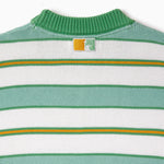Close-up of a green, yellow and white striped sweater with a the WOA Liberty logo on a white background