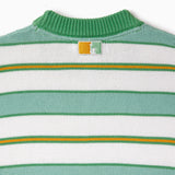 Close-up of a green, yellow and white striped sweater with a the WOA Liberty logo on a white background