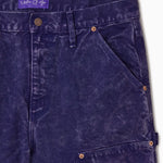 Close Up Of WOA Canvas Carpenter Shorts in Purple with WOA brand label on a white background