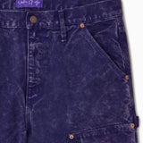 Close Up Of WOA Canvas Carpenter Shorts in Purple with WOA brand label on a white background