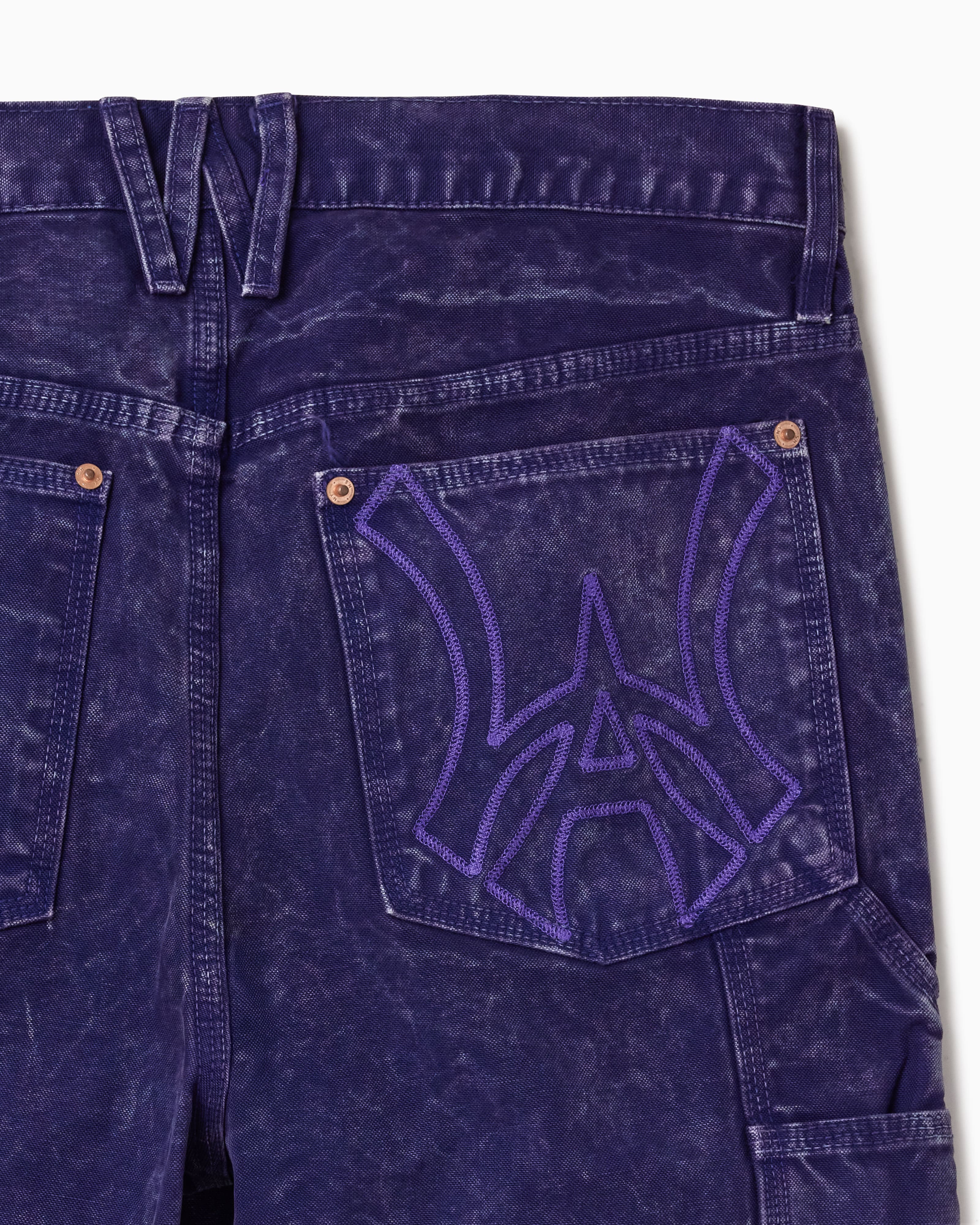 Close up of WOA Canvas Carpenter Shorts in Brick with WA logo on the right back pocket on a white