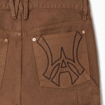 Close up of WOA Canvas Carpenter Shorts in Brick with WA logo on the right back pocket on a white background
