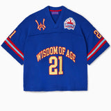 Front view of the Wisdom Of Age Knit Football Jersey in Giant Blue. Wisdom of age written in yellow with a red outline across the midsection with the number 21 in yellow with a red outline.
