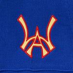 Close up of the front embroidered WA logo on the Wisdom Of Age Knit Football Jersey in Giant Blue