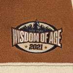 Embroidered Skyline patch on a brown and beige fabric with 'Wisdom of Age 2021' text.