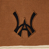 Close-up of a brown fabric with a black WA logo on a beige border