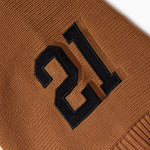 Brown fabric with black number '21' embroidery