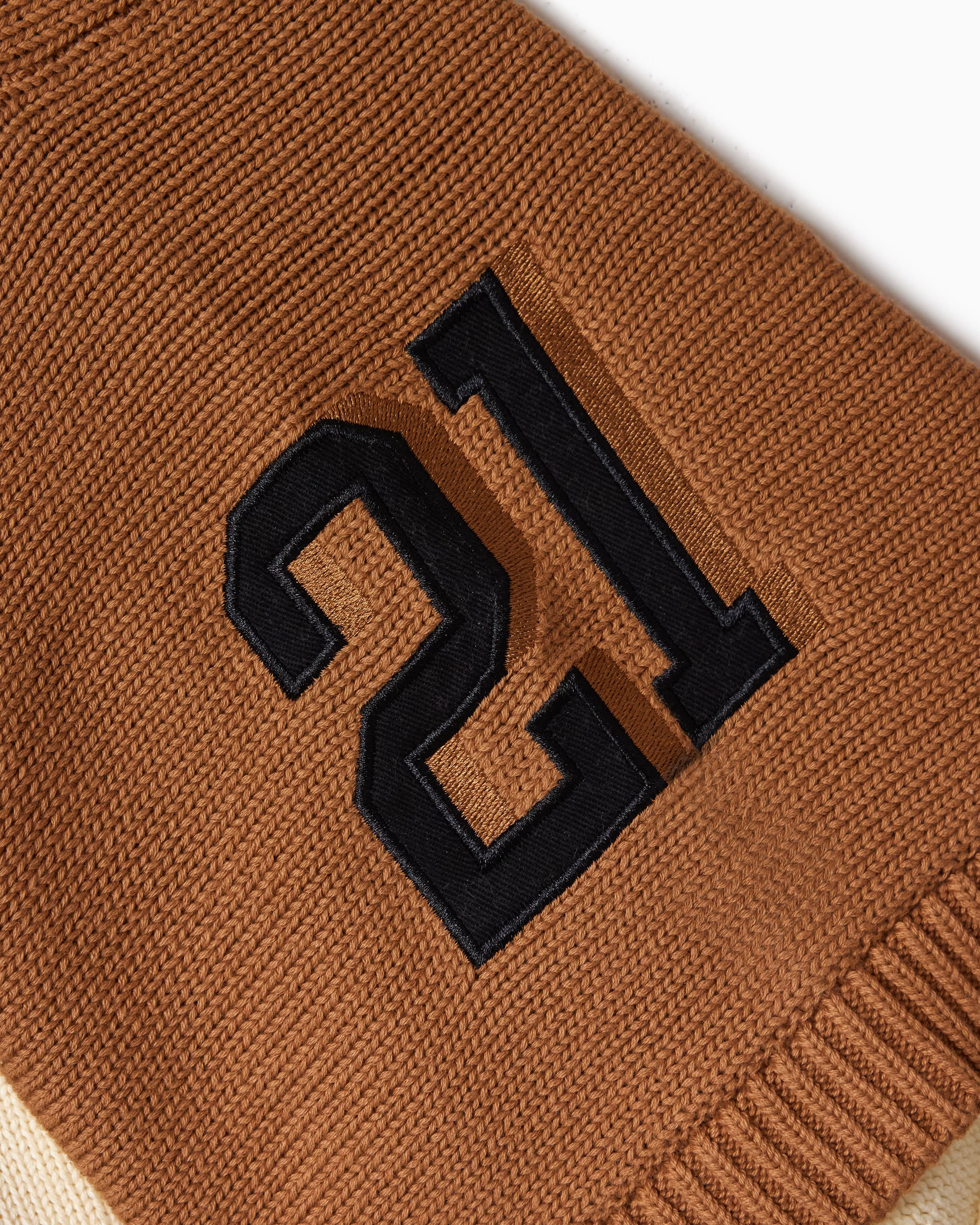 Brown fabric with black number '21' embroidery