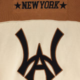 Close-up of the Wisdom Of Age Knit Football Jersey showing the WA logo with 'New York' on the nameplate  on a brown and beige background