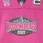 Pink knitted football jersey with Wisdom Of Age logos.