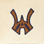 Embroidered WA logo on a cream fabric background