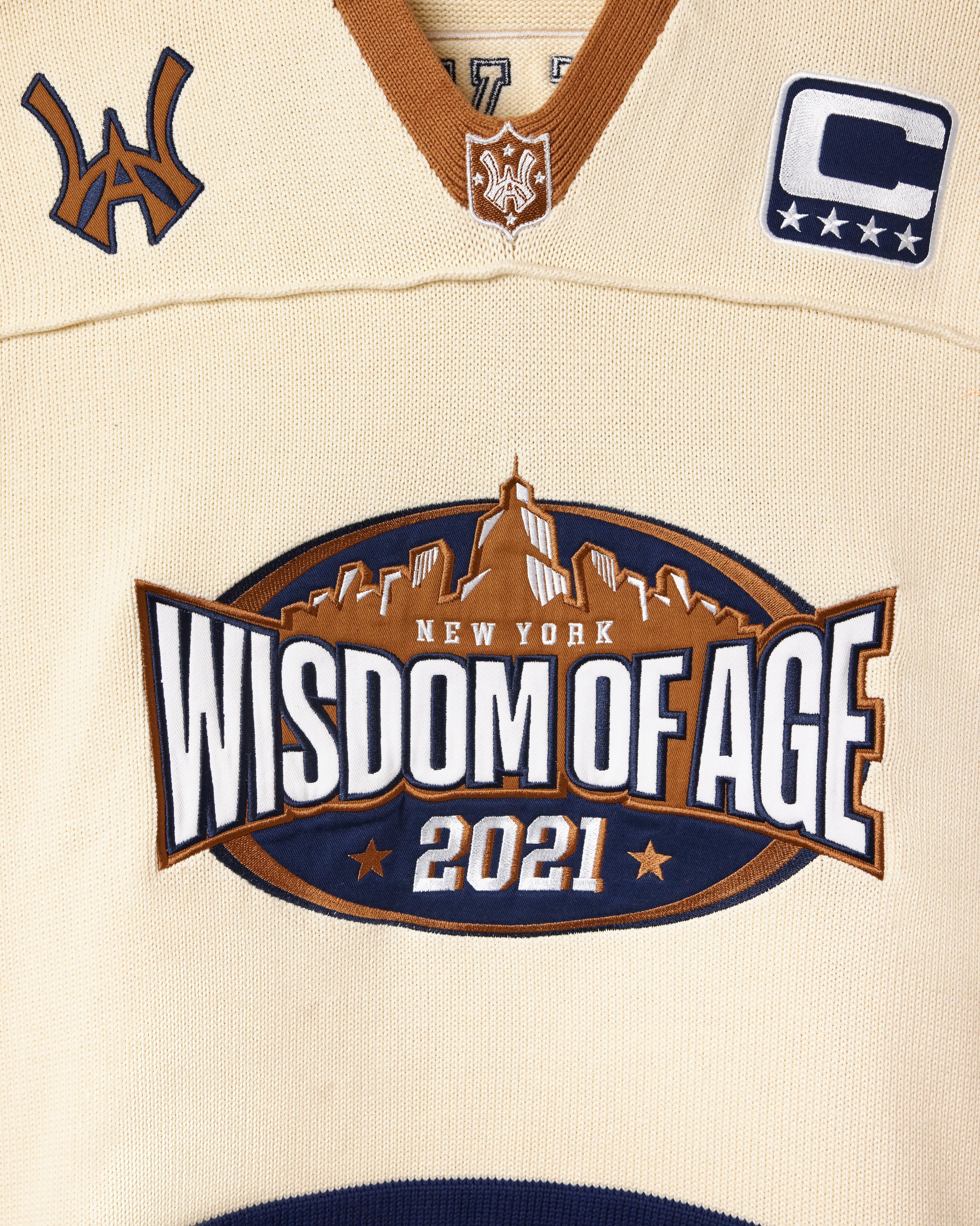 Football jersey with 'Wisdom of Age 2021' logo and the New York Skyline