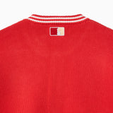Closer look at the back of the cardigan with an embroidered square patch below the nape of the neck and collar. The patch contains the upper half of the Statue of Liberty in a "NY Tough" inspired logo.