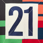 Close up of the rear of the Knit Zip up Hoodie. A navy number 21 within a cream square.