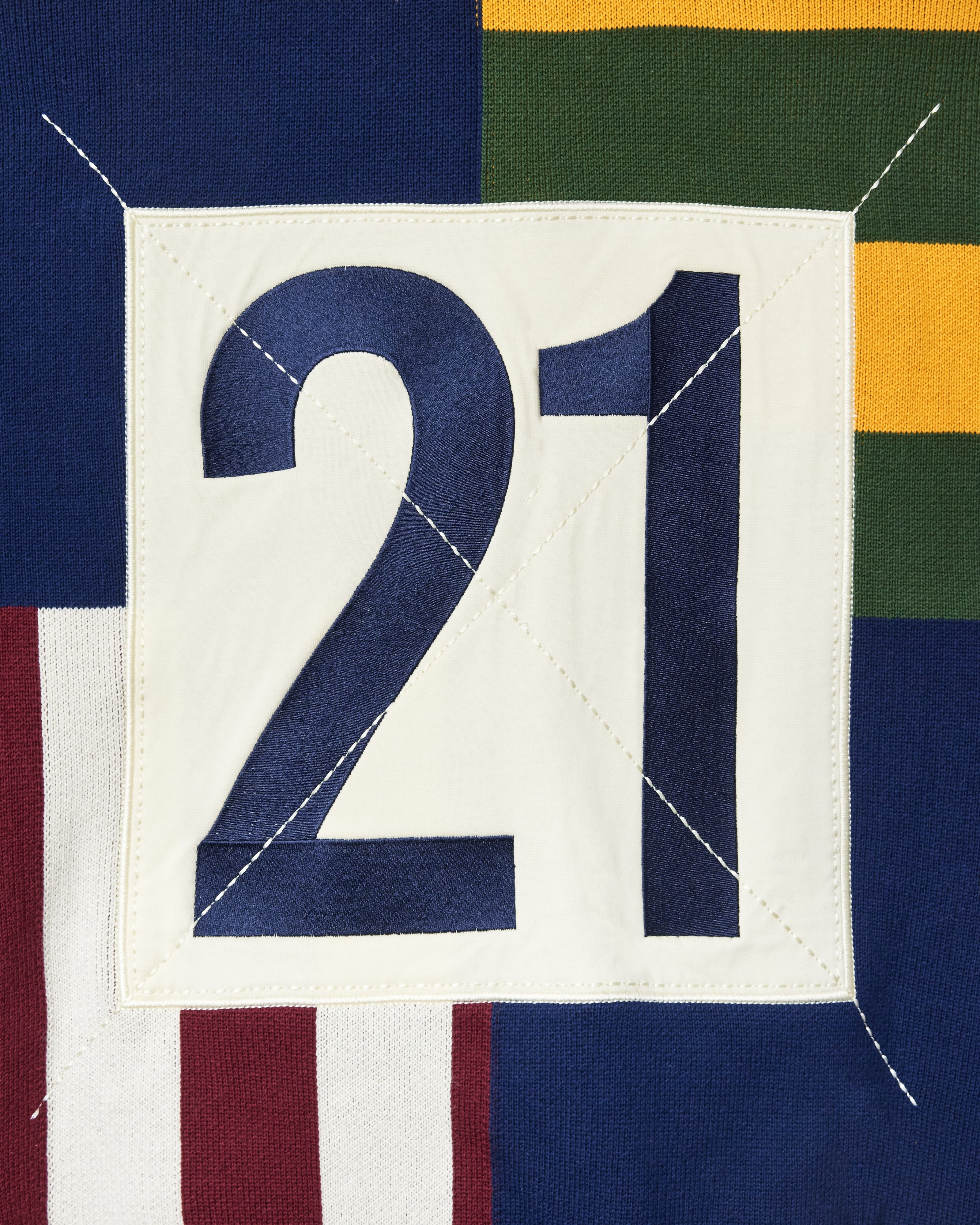 Close Up Of The Wisdom Of Age Knit Clinton Hoodie Multi-Color Rear View. The Number 21 in Navy within a White Square.