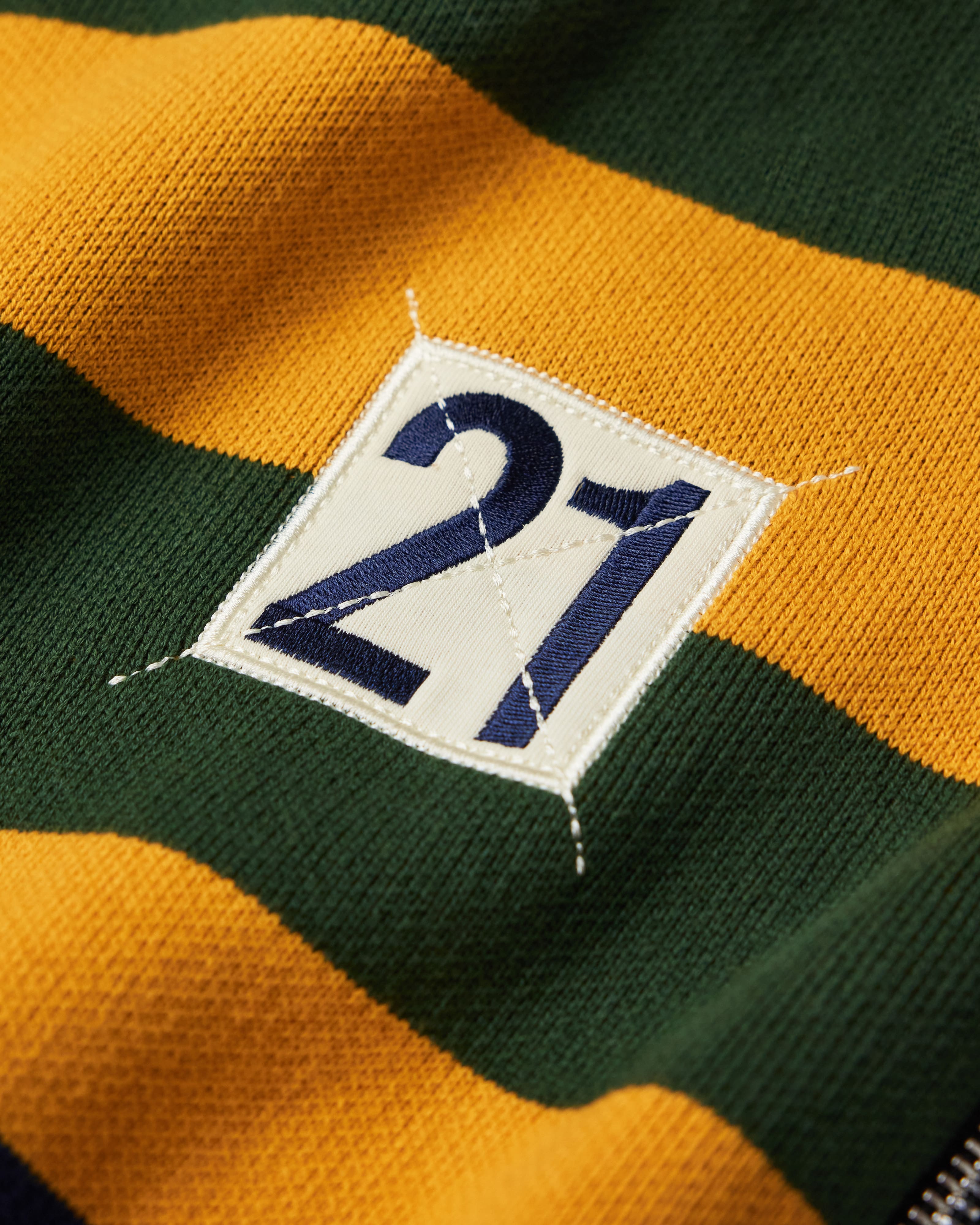 Close Up Of The Wisdom Of Age Knit Clinton Hoodie Multi-Color Front Number 21 in Navy within a White Square.