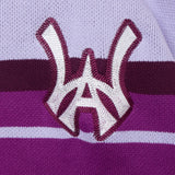 Closer look at the brand logo in a monogram font of connecting the "W" and "A" located on the upper left side of the sweater