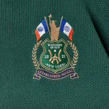 Embroidered WOA logo on a green and red garment with flags and text.