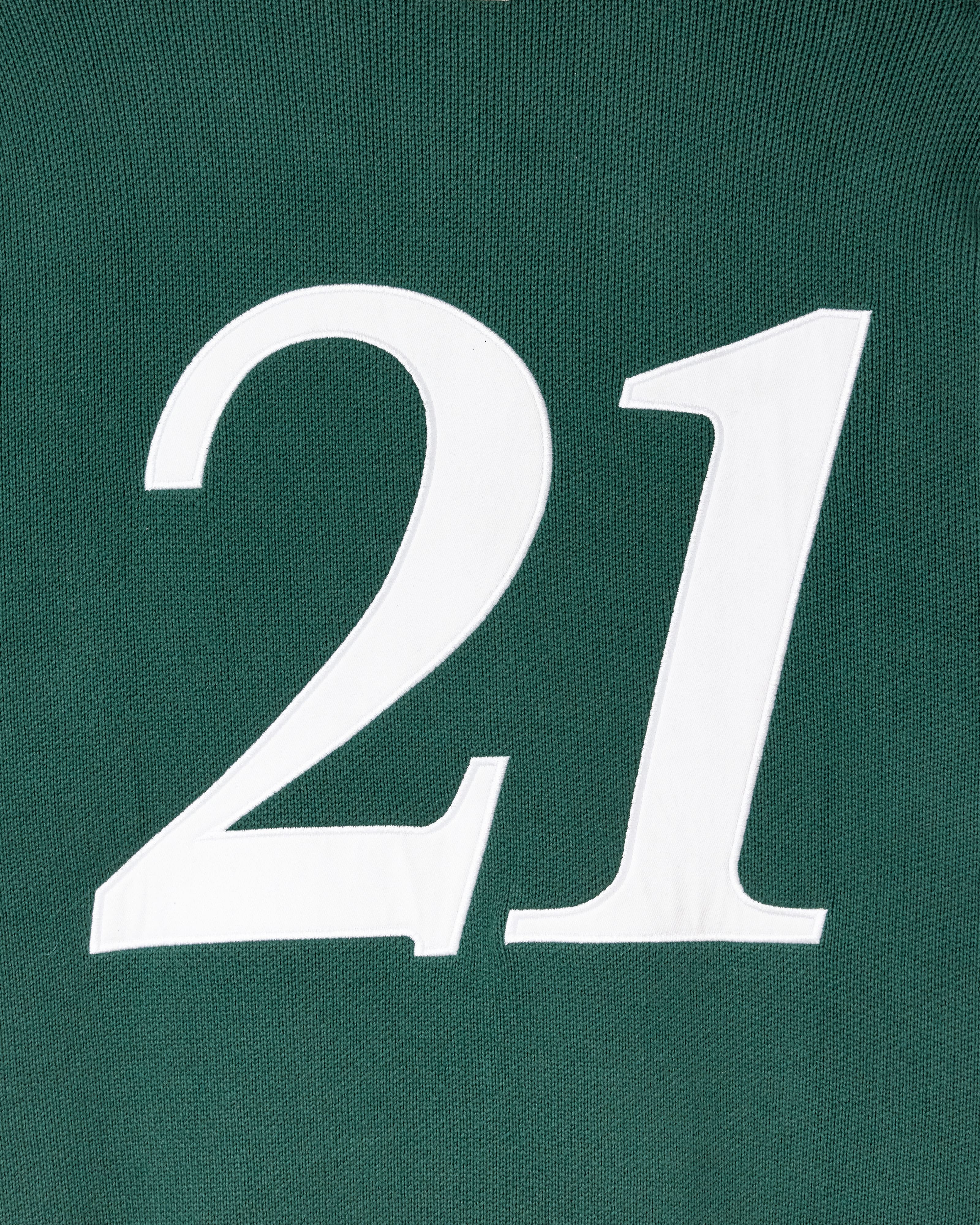 White number '21' on a green background