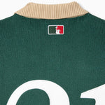 Bleecker Green rugby sweater with the WOA logo on the neck against a white background