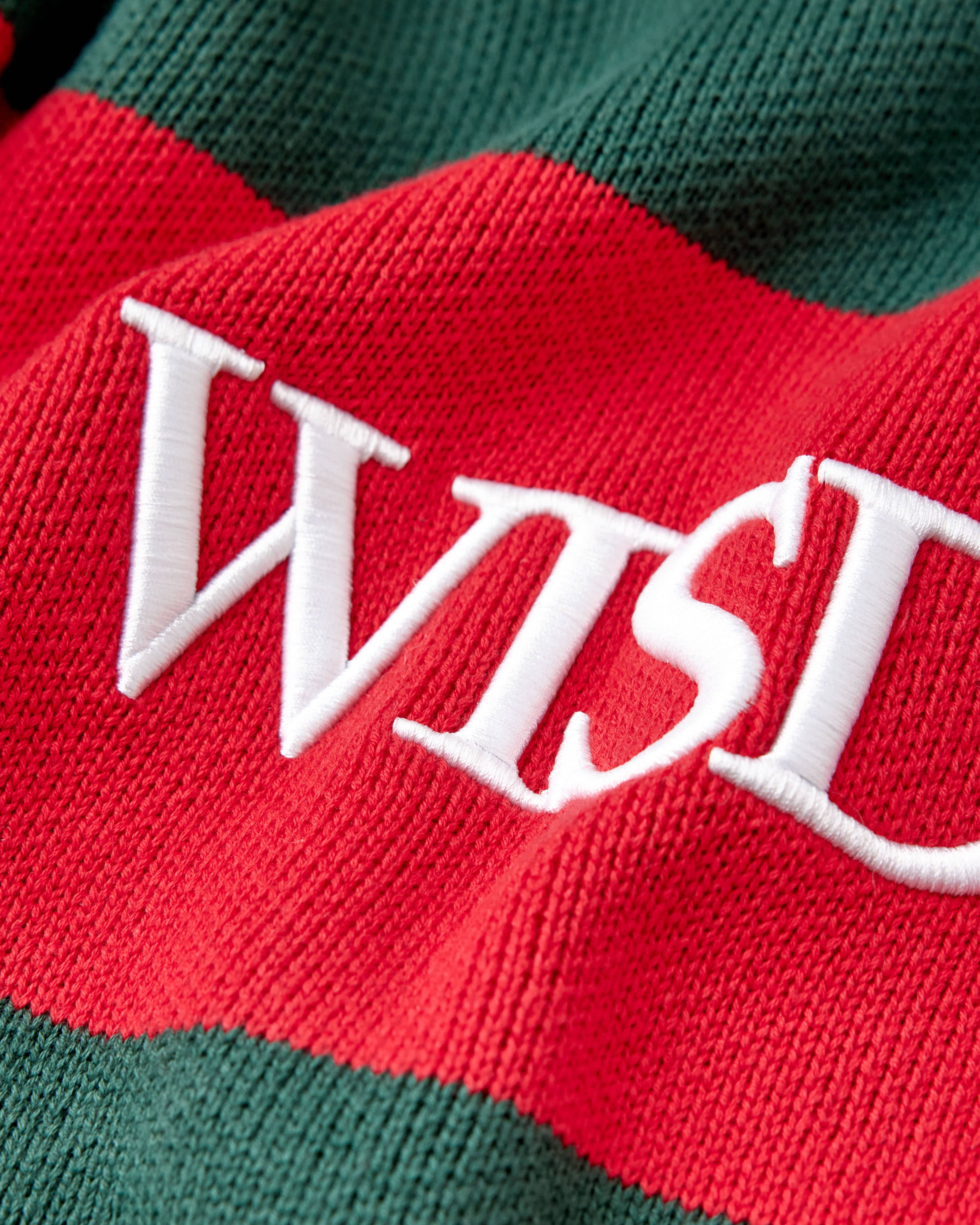 Red and green striped fabric with 'WISD' embroidered in white
