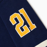 Close Up Of The Wisdom Of Age Knit Hockey Jersey Navy Sleeve View.