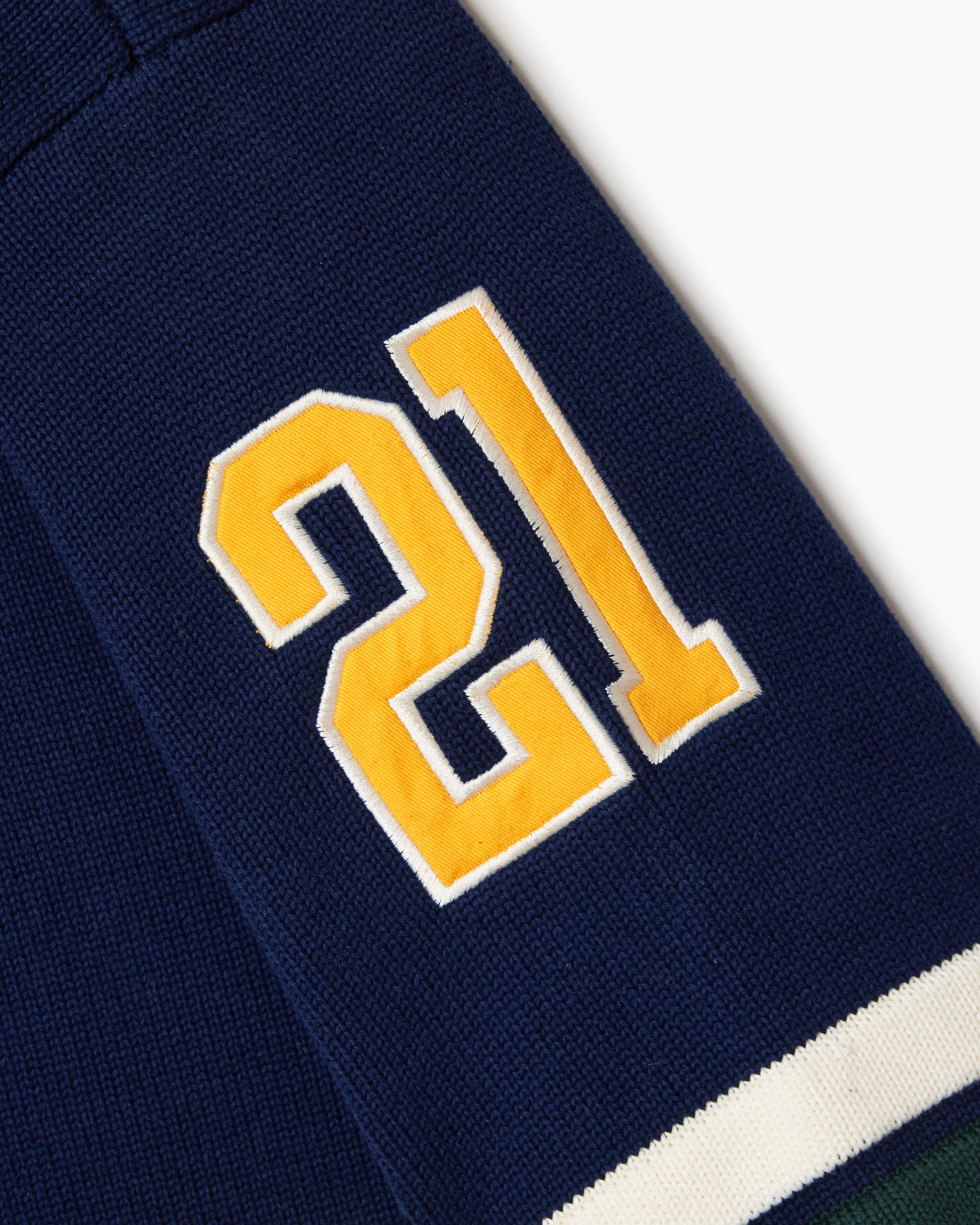 Close Up Of The Wisdom Of Age Knit Hockey Jersey Navy Sleeve View.