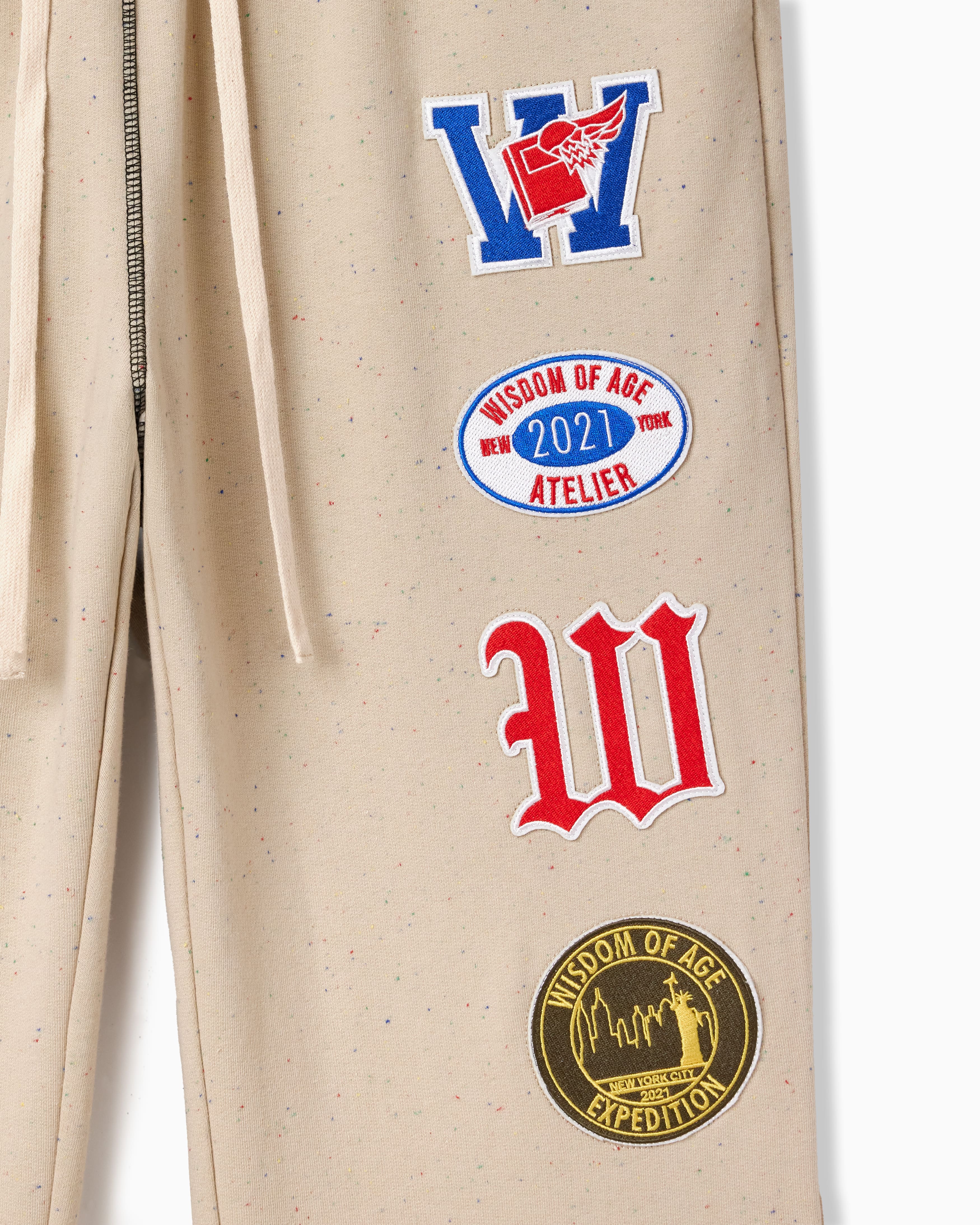 Wisdom Of Age Sandstone pants with patches on a white background