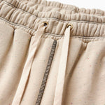 Close-up of Sandstone pants with a drawstring and zipper