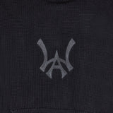 Closer look at the brand logo in a monogram font of connecting the "W" and "A" located on the front chest of the hoodie just above the kangaroo pocket.
