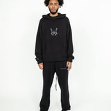 Front head to toe profile of the Knit Hoodie in black. The Hoodie is paired with the Knit Sweatpants in black.