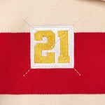 Wisdom of Age Bleecker Rugby Polo in multicolor stripes zoomed front view of embroidered 21 .