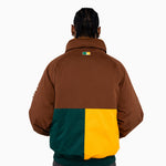 Male Model wearing a brown, green, and yellow jacket on a white background