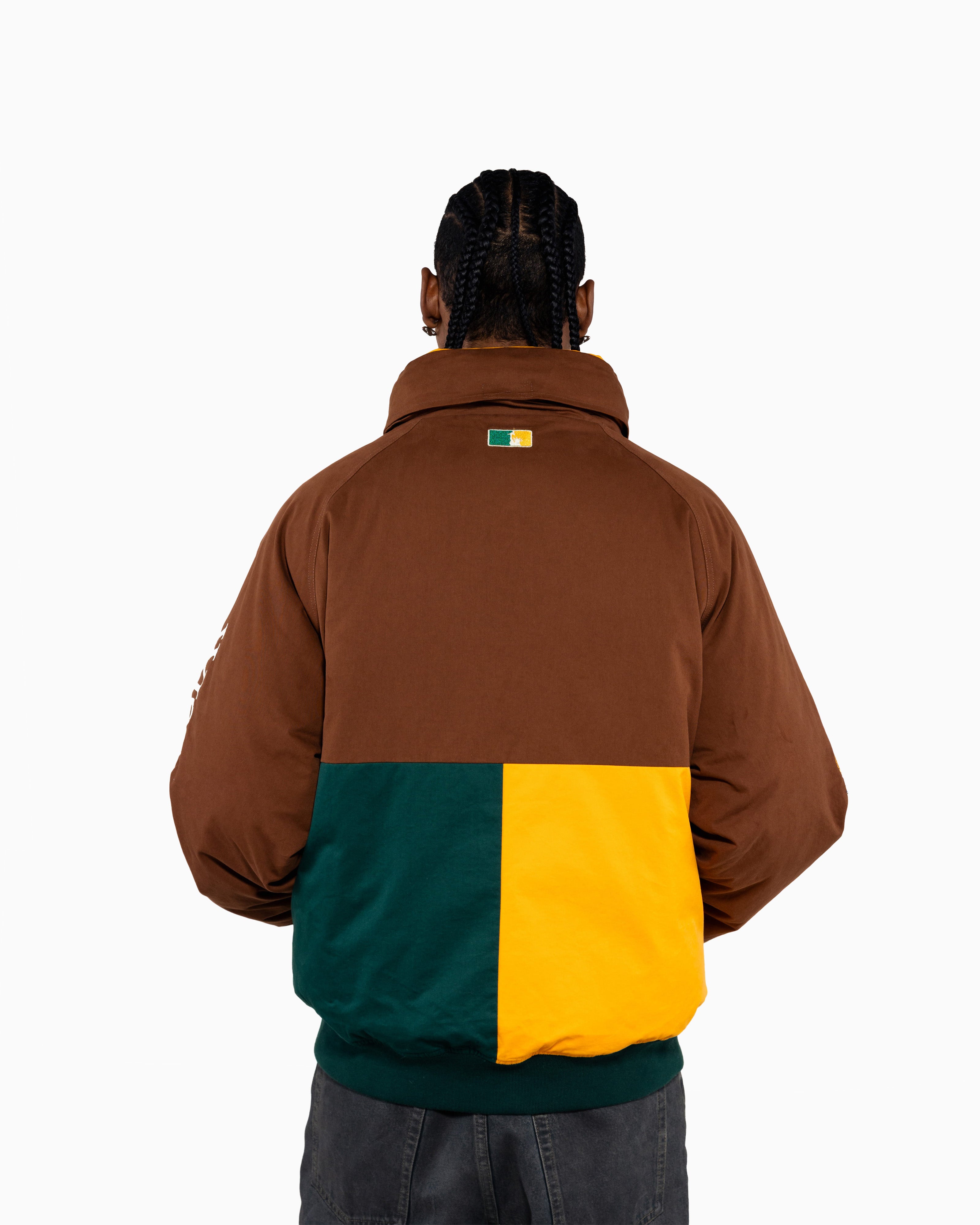 Male Model wearing a brown, green, and yellow jacket on a white background