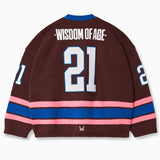 Rear view of the Wisdom Of Age Knit Hockey Jersey with the number 21 in white with a blue outline on the center, Wisdom of age on the name plate. Pink Stripe followed by a blue stripe followed by a pink stripe.