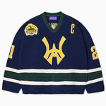 Front view of the Wisdom Of Age Knit Hockey jersey Navy. WA logo on the front with  and captains C on the left shoulder and a nyc skyline patch on the right shoulder. the number 21 on the sleeves
