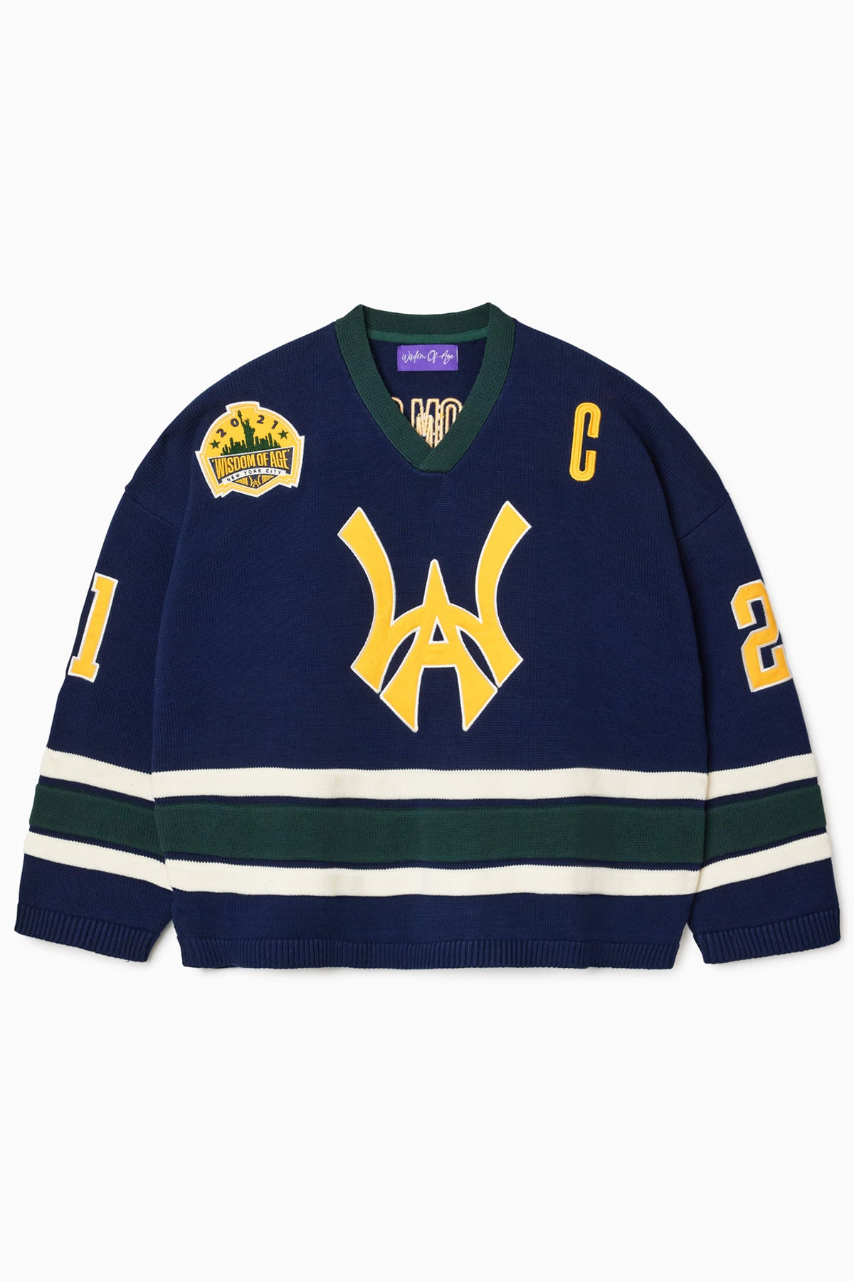 Front view of the Wisdom Of Age Knit Hockey jersey Navy. WA logo on the front with  and captains C on the left shoulder and a nyc skyline patch on the right shoulder. the number 21 on the sleeves