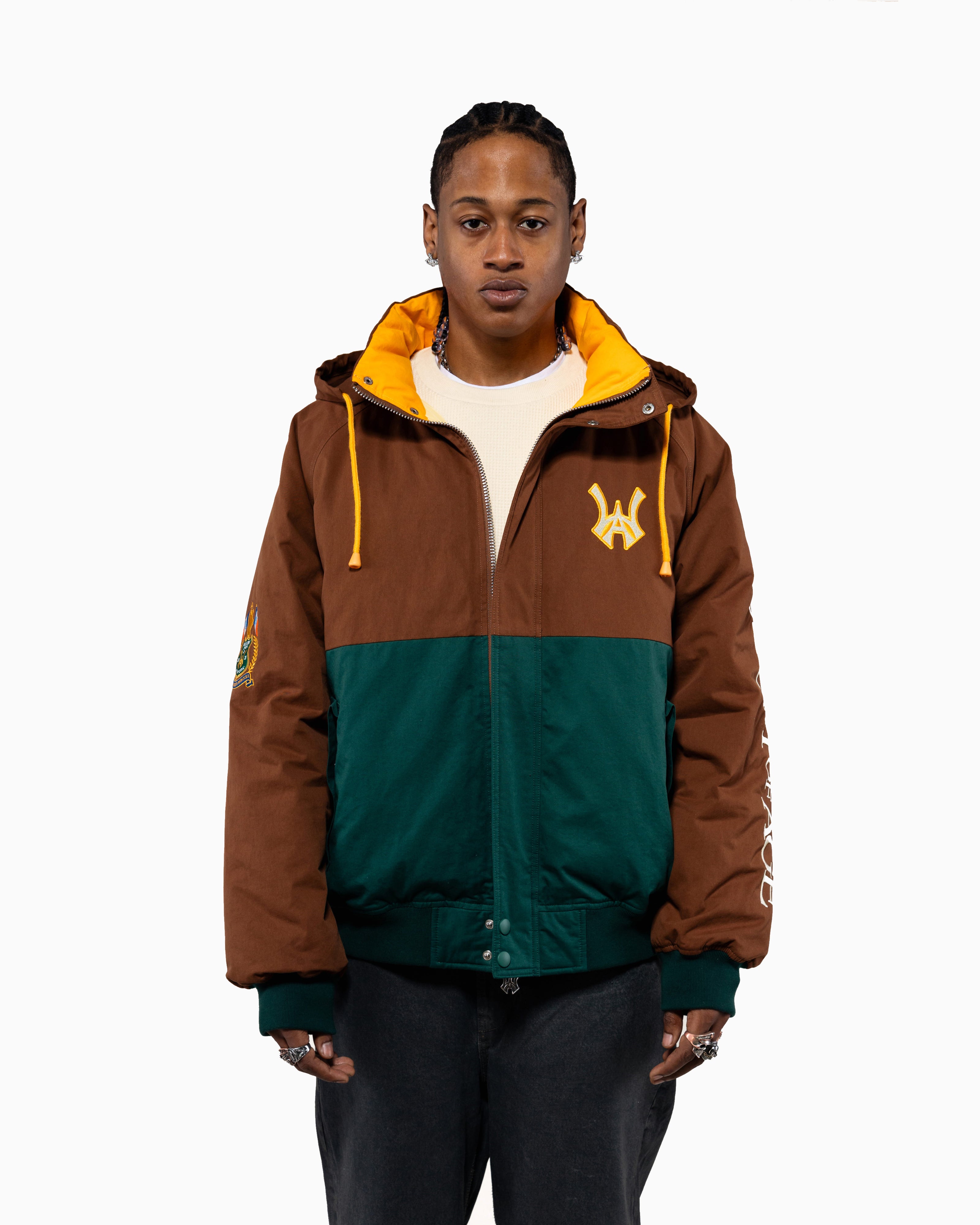 Male Model wearing the Harbor Sailing Jacket  in Mocha / Marine Greent with yellow accents on a white background